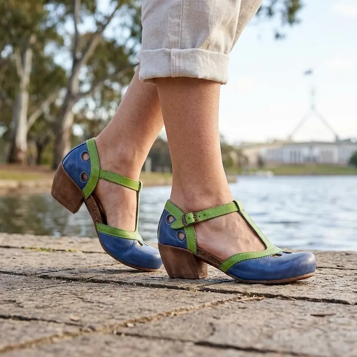 Blue and green heeled sandals on foot by the water, AI product photo